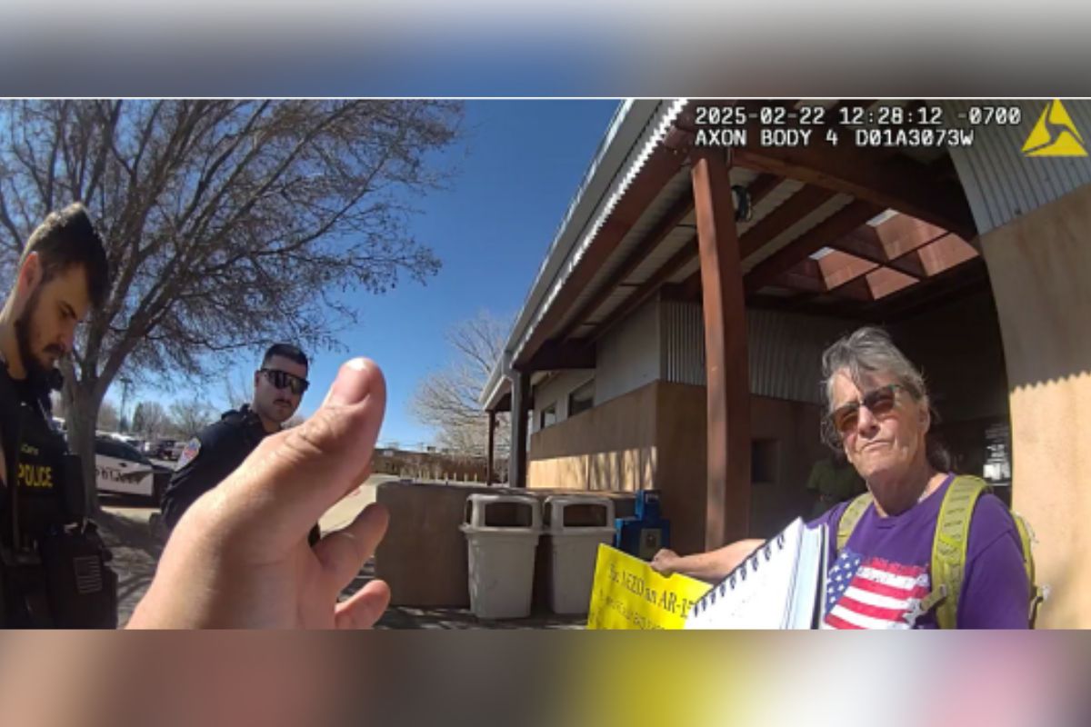 Jill Gatwood, an Albuquerque resident represented by the American Civil Liberties Union of New Mexico, alleges in the lawsuit that she was unlawfully arrested Feb. 22 while holding a handmade sign advocating for restrictions on assault-style weapons on a public sidewalk outside the Moriarty Civic Center. (Still from Moriarty Police Officer’s body camera)