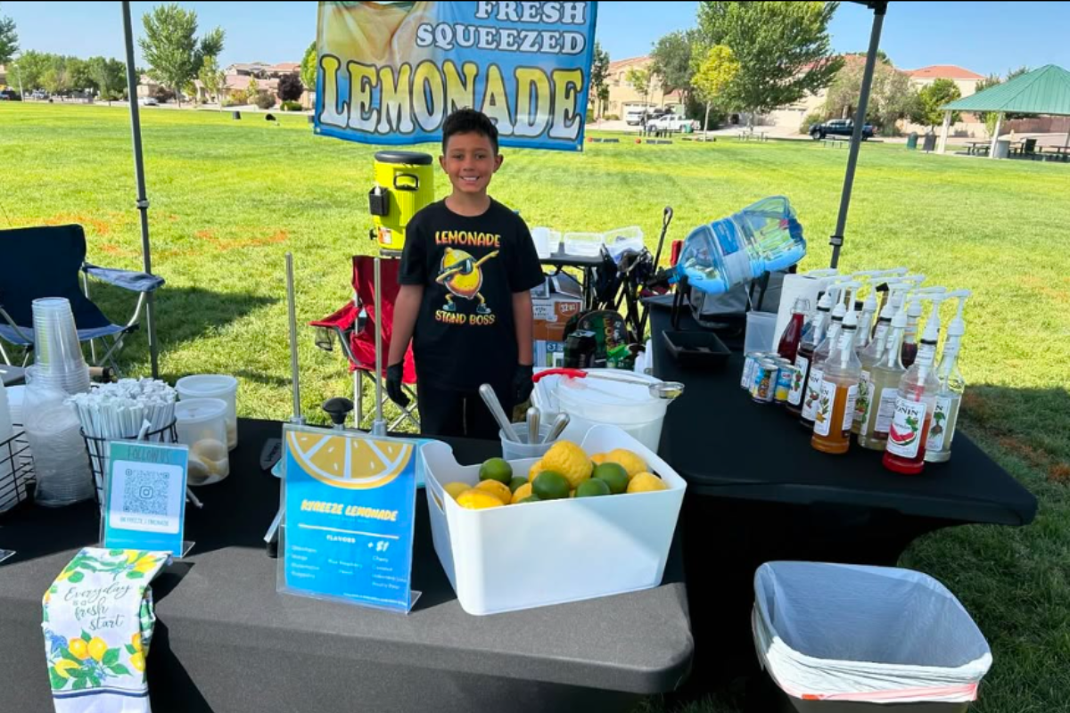 Khalil Lorando, the 11-year-old CEO of Kyreeze Lemonade, manages orders at a recent community event. Lorando balances school with his growing business, saving his earnings to purchase a Jeep Wrangler by age 16.