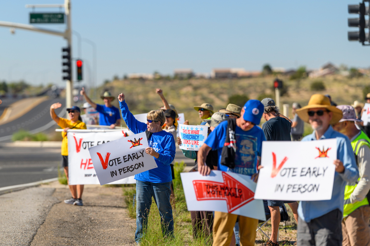 Signs of the times: No Kings rally points first-day early voters toward the polls